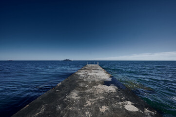 view from the pier to the yacht in the sea