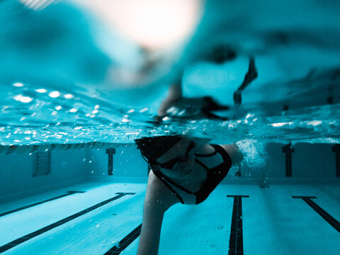 Woman crawling in a pool preparing for a competition