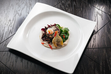 Filet mignon served on a white plate in restaurant