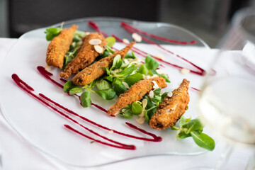 Crispy deep fried small fish in Italian style with some delicious salad and sauce
