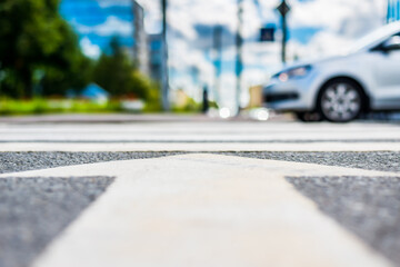 In the downtown, the white car passes a crossroads. View from the pedestrian crossing level