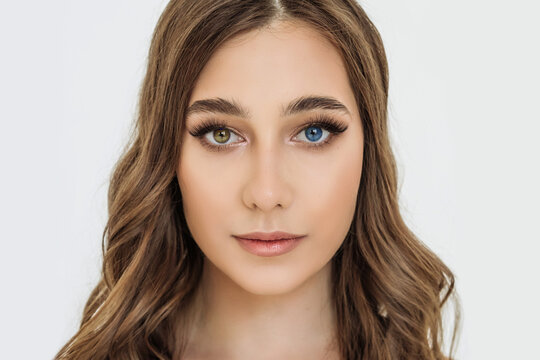 heterochromia in an attractive Caucasian young woman. face close-up, portrait of a beautiful woman with eyes of different colors of blue and brown. melanin, genetics