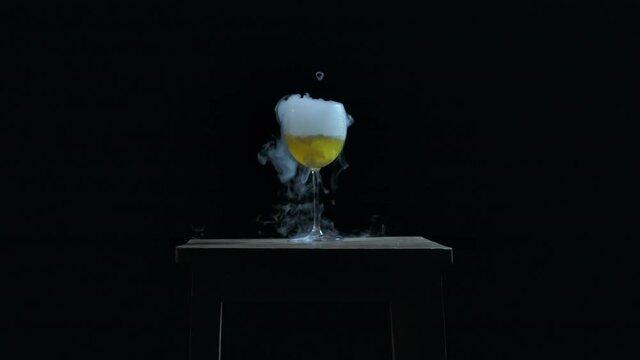 The abstract  smoke in the glass. White wine in glass with dry ice