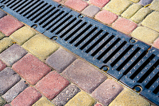 Stormwater cast iron drainage system in a pavement. Is used for drainage and separation of water from footpath.