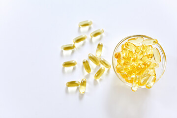 Omega 3 capsules lying on white background. Fish oil in pills. Health support and treatment....