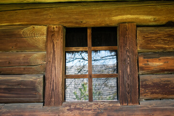 Wooden wall with window. Rustic style. Ecological housing. 