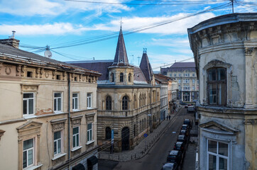 Fototapeta na wymiar Old vintage residential buildings on narrow street in the historical center of the Lviv city it the early morning. Ukraine