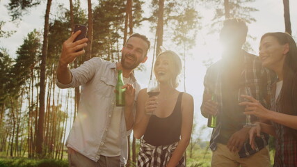 Smiling friends sending greetings on camera outside. Guys having video call