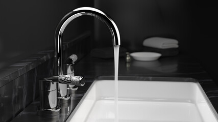 faucet water running in dark bathroom