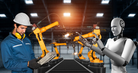 Mechanized industry robot and human worker working together in future factory . Concept of artificial intelligence for industrial revolution and automation manufacturing process .