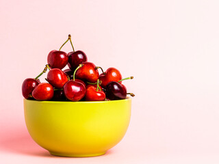 Green bowl with cherries on a white background with copy space.
