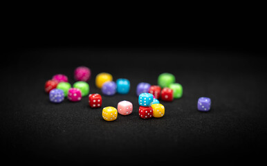 Stacked colored dice on a black background