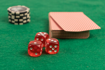 three red dice close-up on a green background