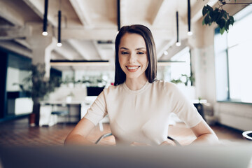 Close up portrait of a young woman working in office at the table