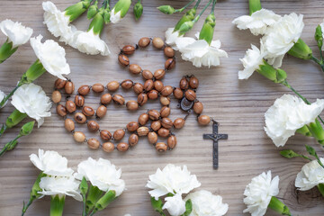 wood rosary with white flower border