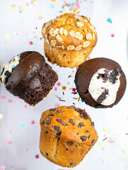 Variety of fresh muffins with colourful sprinkles