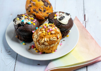 Variety of fresh muffins with colourful sprinkles