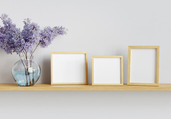 Three photo mockup frames and bouquet of lilac blossoms on the shelf. Clipping path included. 3D...