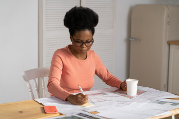 Concentrated freelance architect draw project blueprint work from home. Remote interior designer...