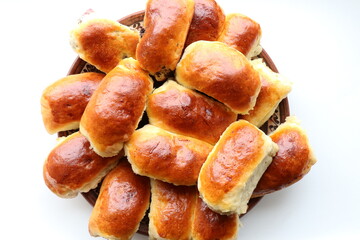 Homemade buns on a plate on a white background