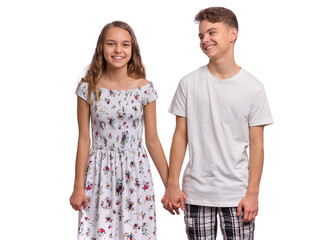 Portrait of smiling teen boy and girl holding hands together. Happy children in casual clothes, isolated on white background. Teenagers looks at camera. Friendship and love concept