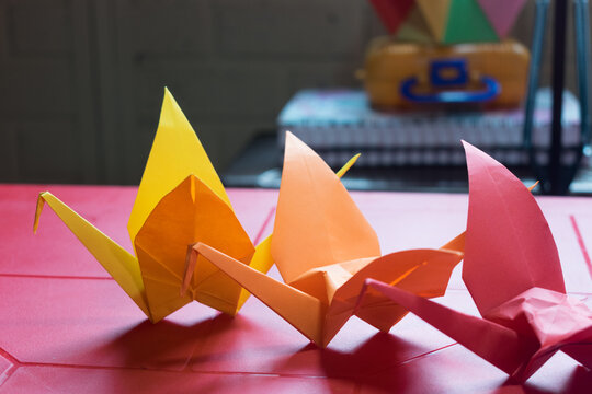 colorful cranes on a red plastic table