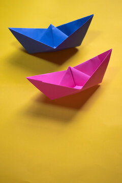 origami paper boats with a yellow background