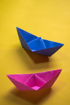 origami paper boats with a yellow background