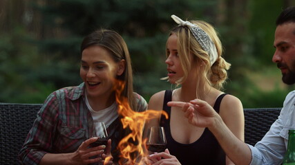 Relaxed fellows having rest on backyard. Cheerful men talking on grill party