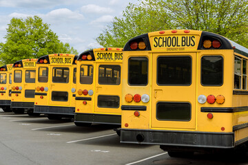 Naklejka na ściany i meble Yellow school bus for children educational transport on the street