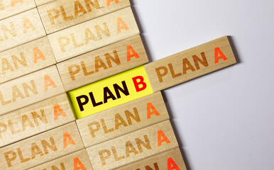 Plan b word written on wood cube with gray background.