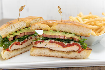 Layers loaded into this chicken sandwich stacked high with meat and fillings along with french fries