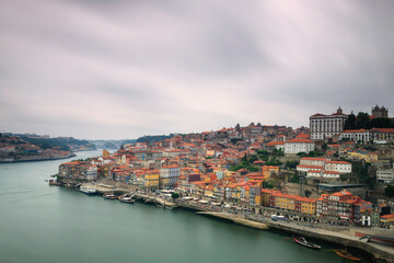 Naklejka premium Oporto, Portugal, Europe. Postcard from the picturesque city of Porto, amazing travel destination in Portugal. View to the historic center of the city, Douro River with its beautiful bridge