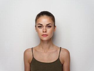 pretty young woman in a t-shirt on a light background hairstyle makeup model