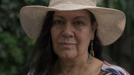 Close up of adult serious woman looking at camera with confidence