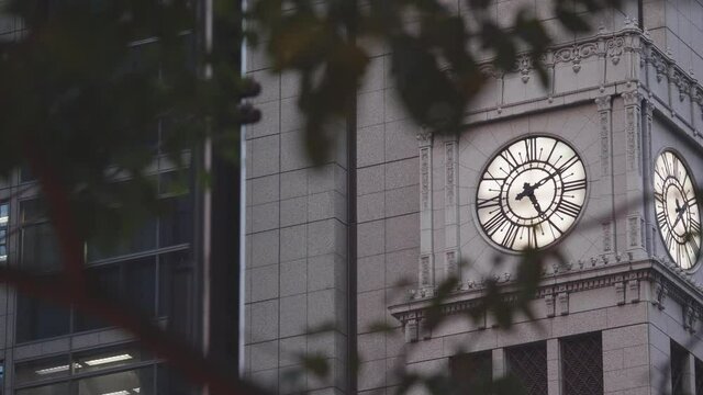 The famous clock tower in Ginza, Tokyo, a bird in flight