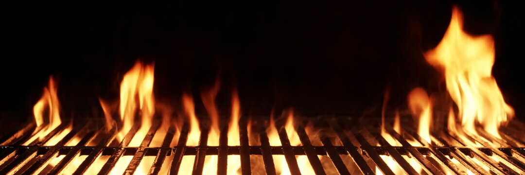 Barbecue Fire Grill Isolated On Black Background. BBQ Flaming Charcoal Grill Isolated. Hot Barbeque Charcoal Cast Iron Grill With Bright Flames Of Fire. Abstract Panoramic Grill Wide Banner.