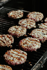 burger cutlets on a grill - cutlets made from organic beef. raw cutlets