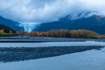 dramatic, moody sky during autumn sunset in the Exit Glacier in Kenai Ffjords national park , Alaska.