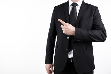 Obraz na płótnie Canvas young successful businessman. Market broker man on white background, wearing suit with tie and pointing at a copy space with his finger