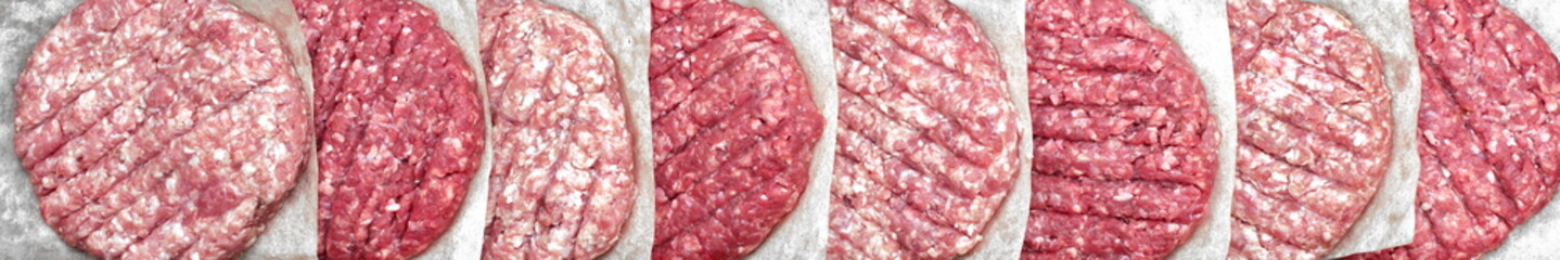 Raw Beef Hamburger Patties On Paper And Black Background, Overhead View. Raw Burger Cutlets On Isolated Background, Top View. Many Raw Minced Steak Burgers from Beef Pork Meat on Black Background.