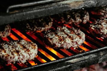 burger cutlets on a grill - cutlets made from organic beef. raw cutlets