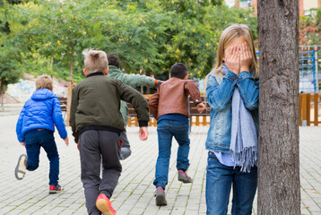 Kids playing hide and seek on the street. High quality photo
