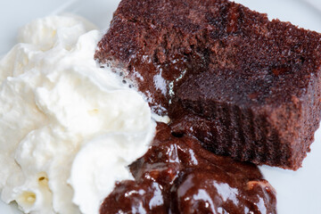 chocolate brownie with oozing runny filling and whipped cream 