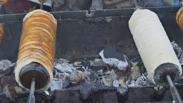 Trdelnik bakery popular dish among tourists on the street market a spit on an open fire in Prague, Czech Republic