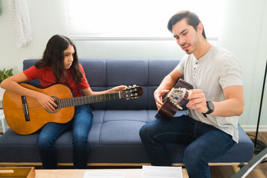 Instructor and student tuning their musical instruments