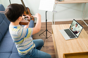 Talented boy learning to play the violin online