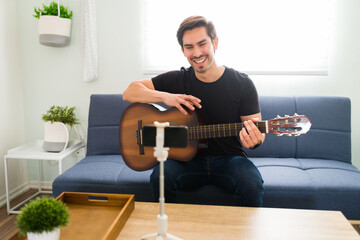 Obraz premium Excited young man giving online music lessons