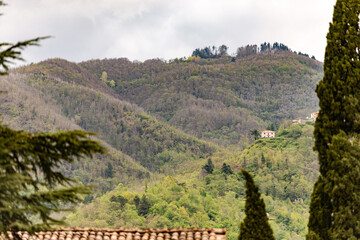 Tuscan mountains with houses on the slopes. Spring in May in the heart of Italy.