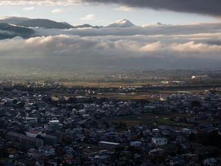Scenic view of Matsumoto city with Northern Alps in the background at sunset, view from Joyama park observation tower - Nagano prefecture, Japan